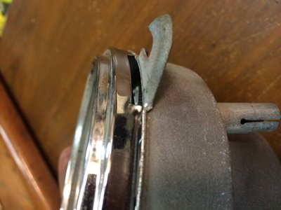 Just carefully pry off the metal housing that holds the glass. Go back and forth on both sides until it pops off.