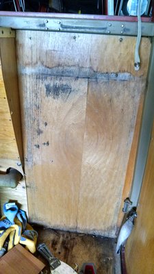 Behind the wash basin cabinet a lot of old mold and stains